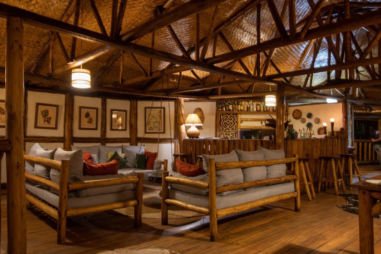 The warm timbered main room of a forest lodge