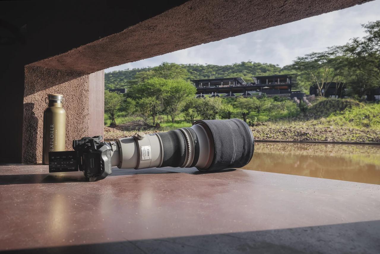 A camera and long lens rest ready at the lodge