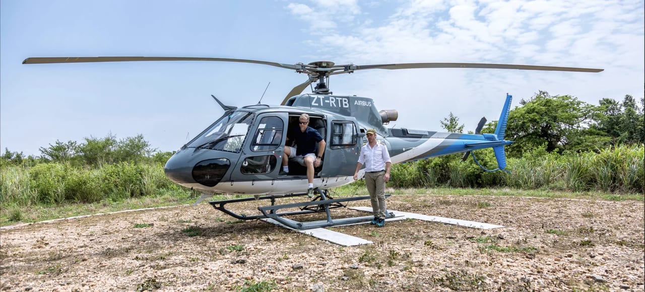 Guests board a helicopter for the flight toward gorilla country