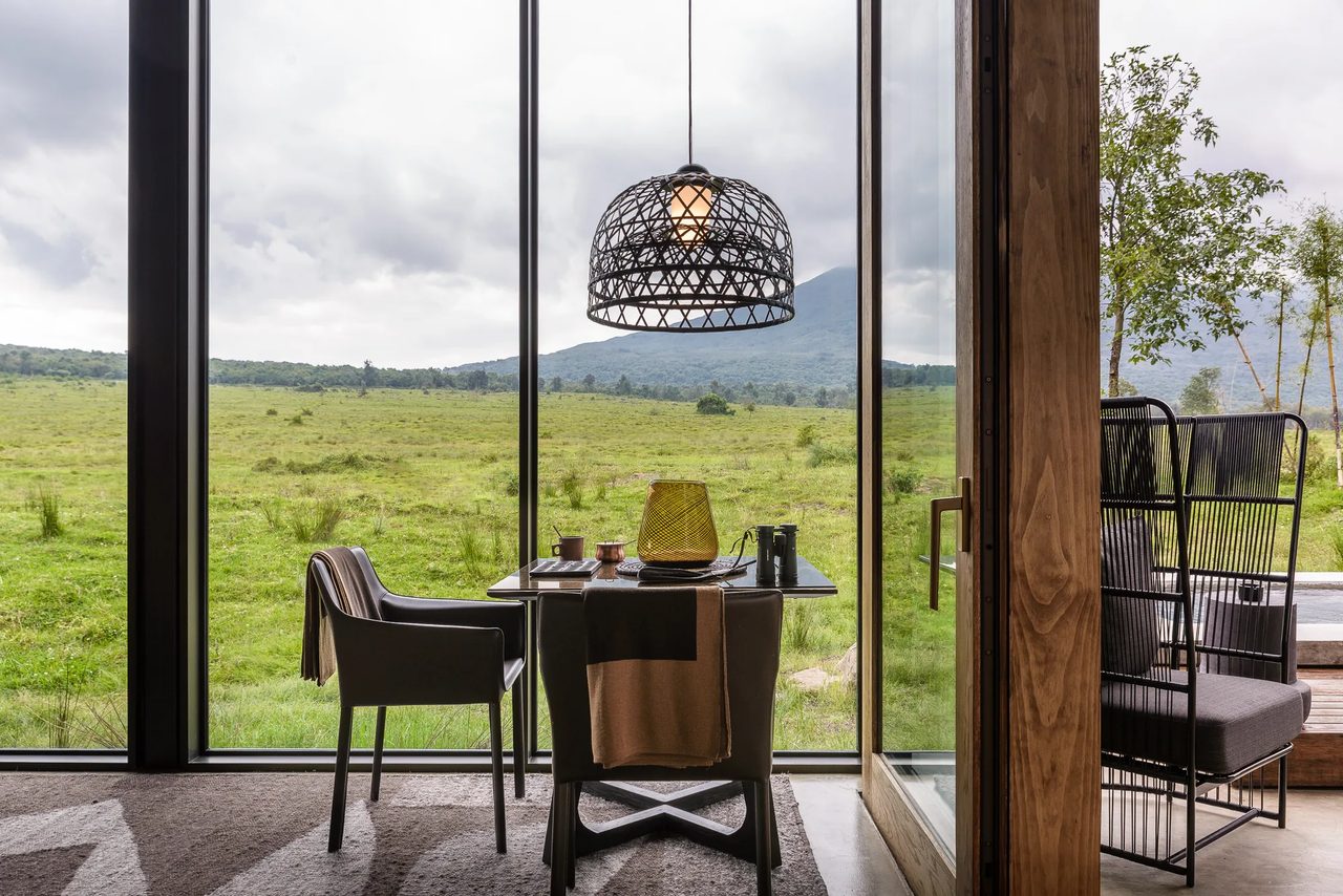 A dining table laid with a wide view over the plains