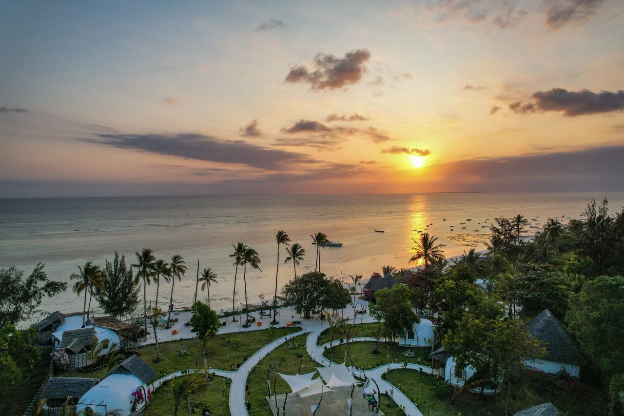 Sunset over the beach and palms at Kizimkazi on Zanzibar's south coast