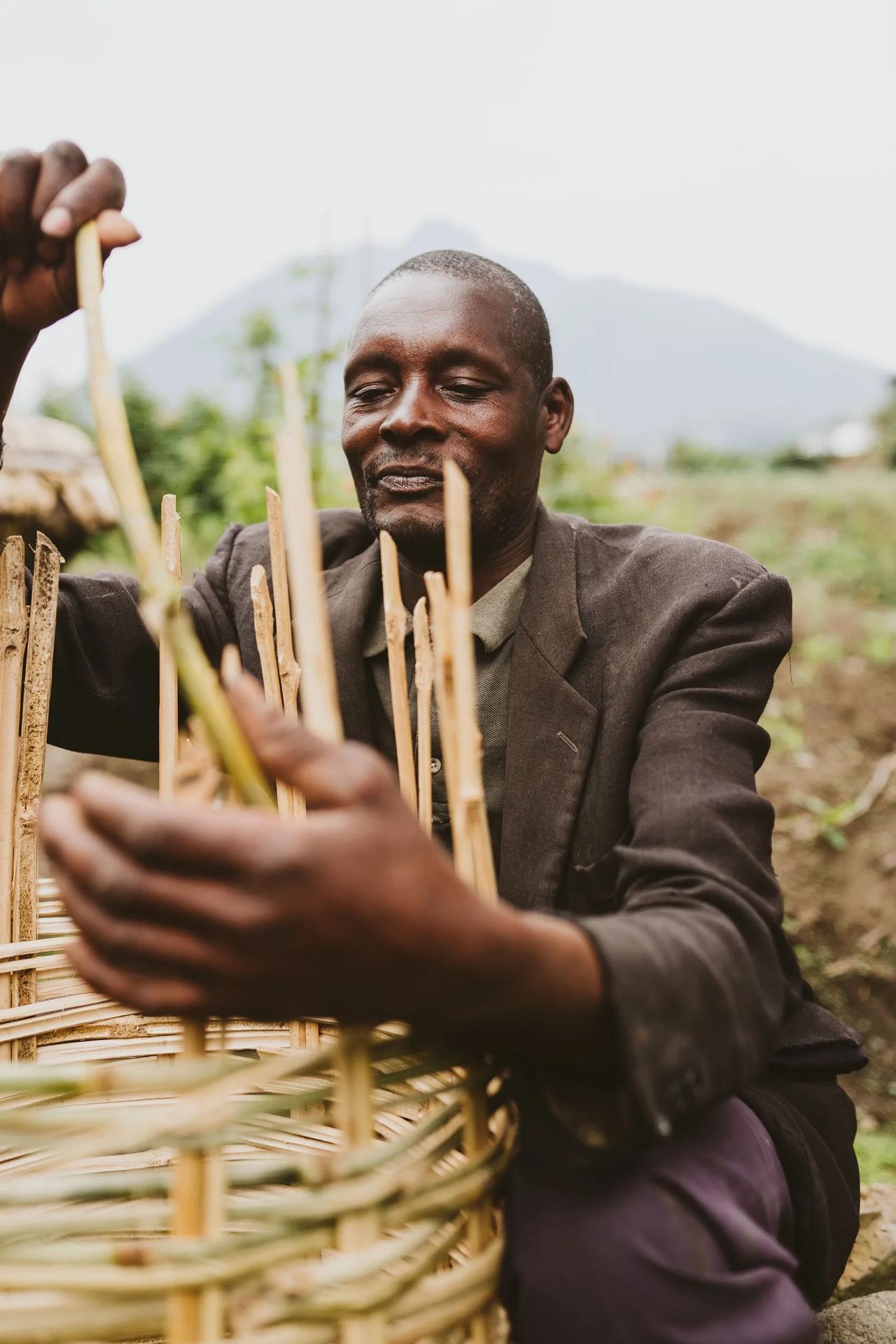 A craftsman weaves a basket by hand