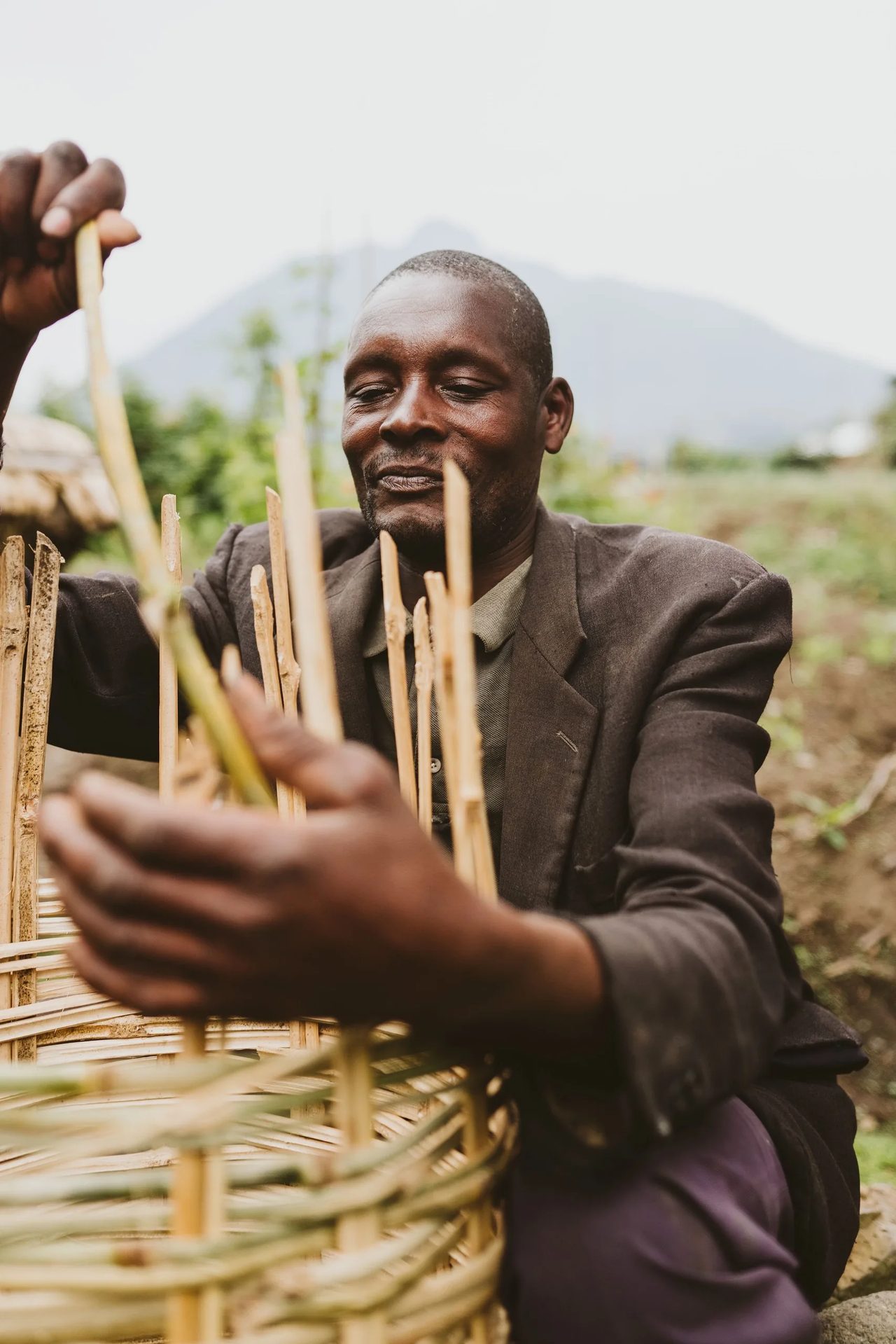 A craftsman weaves a basket by hand