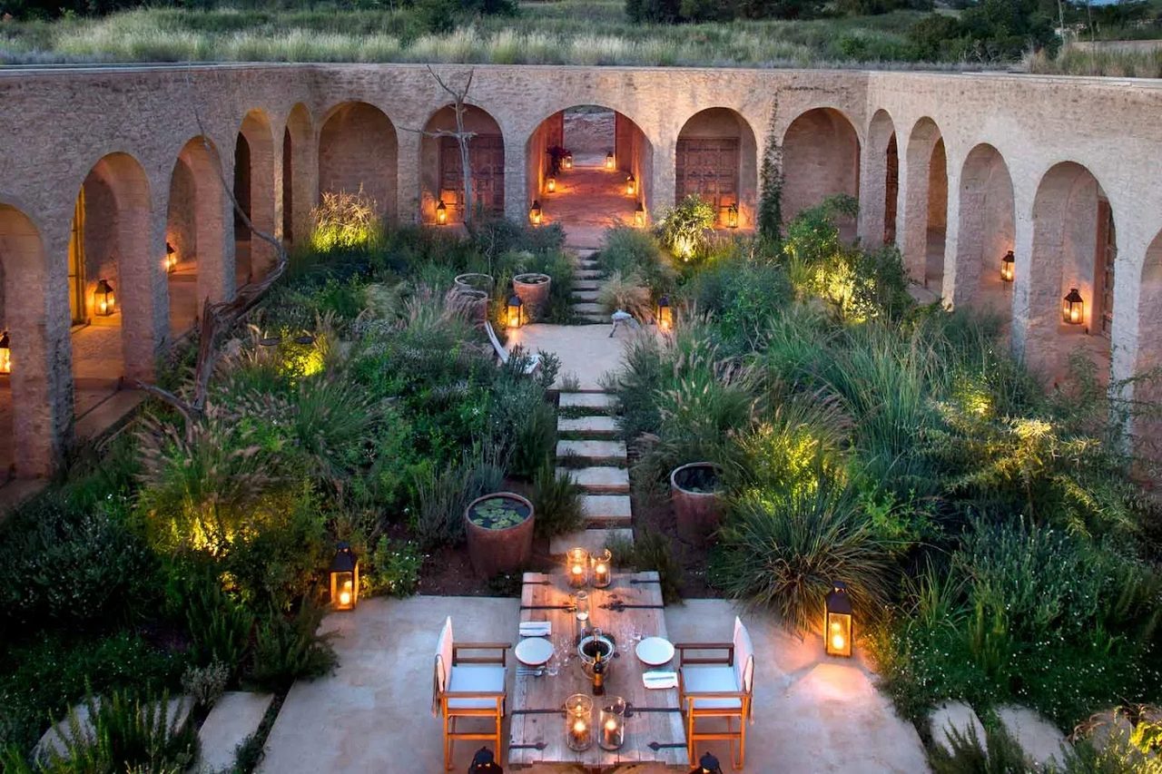 A private courtyard dinner laid under lanterns at an exclusive-use house in Kenya