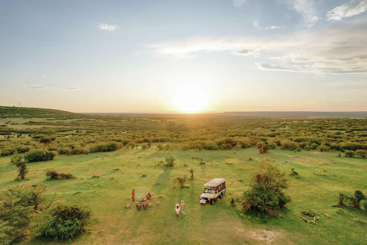 A private conservancy breakfast on the green plains of the Mara ecosystem, seen from above