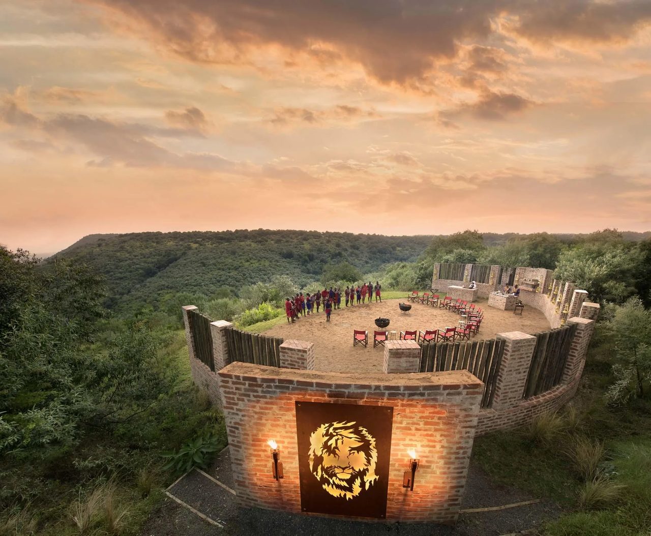 A fire-lit sundowner boma seen from the air at dusk