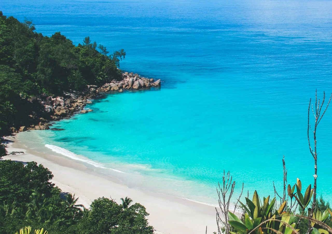 A granite-framed cove with white sand and clear water in the Seychelles