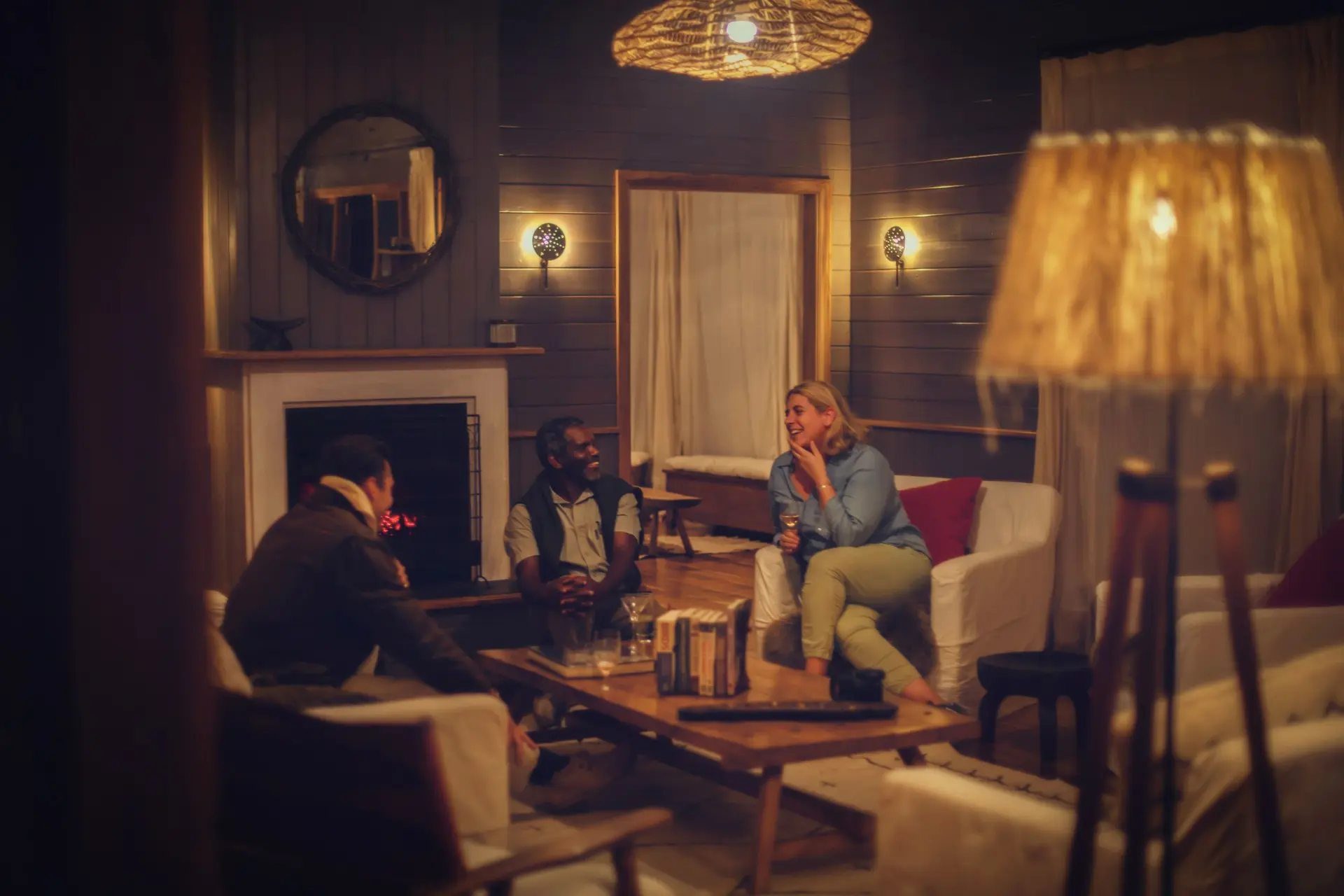 A Sail safari guide sharing stories with guests beside the fire