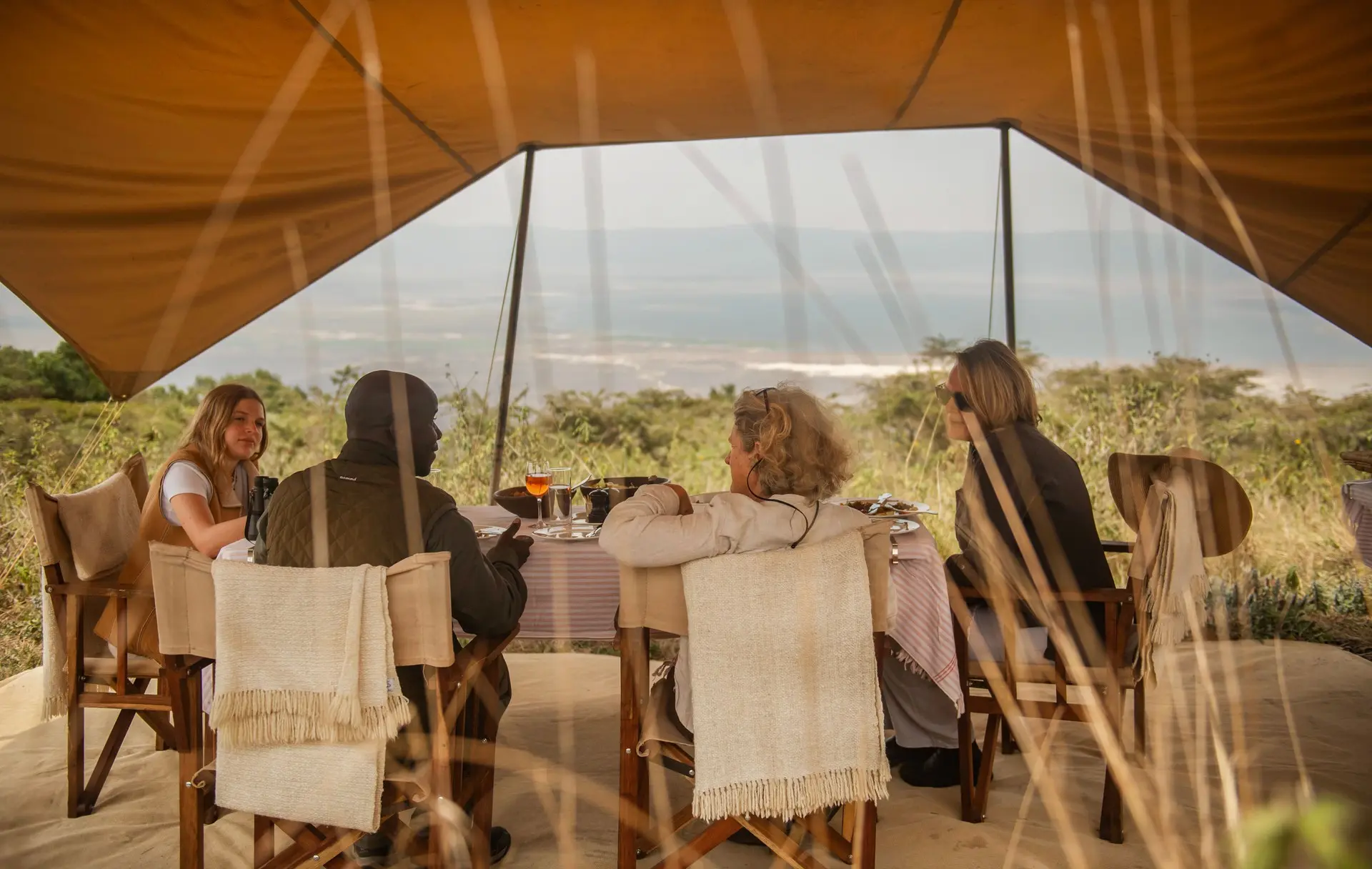 A Sail guide in conversation with safari guests over a private meal