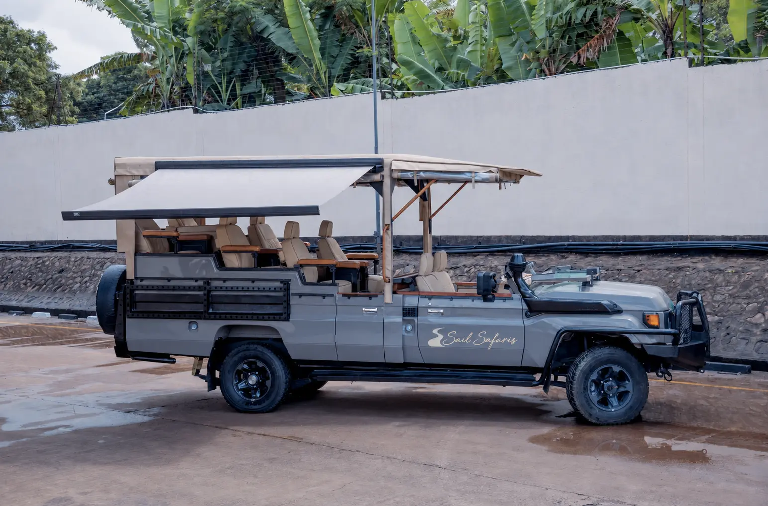 A branded, open-sided Sail Safaris vehicle