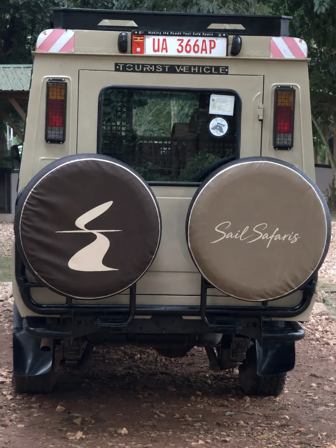 The Equator Fold symbol and Sail Safaris wordmark displayed on vehicle spare-wheel covers