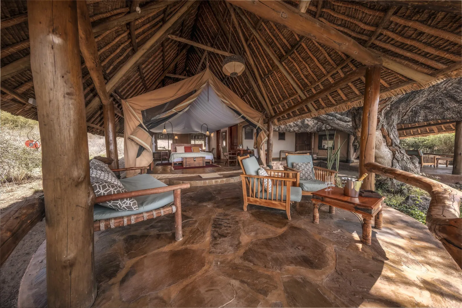 A thatched camp lounge opens toward the mountain's side of the sky