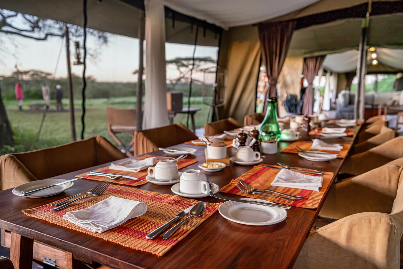 A seasonal camp's dining tent stands ready for the evening