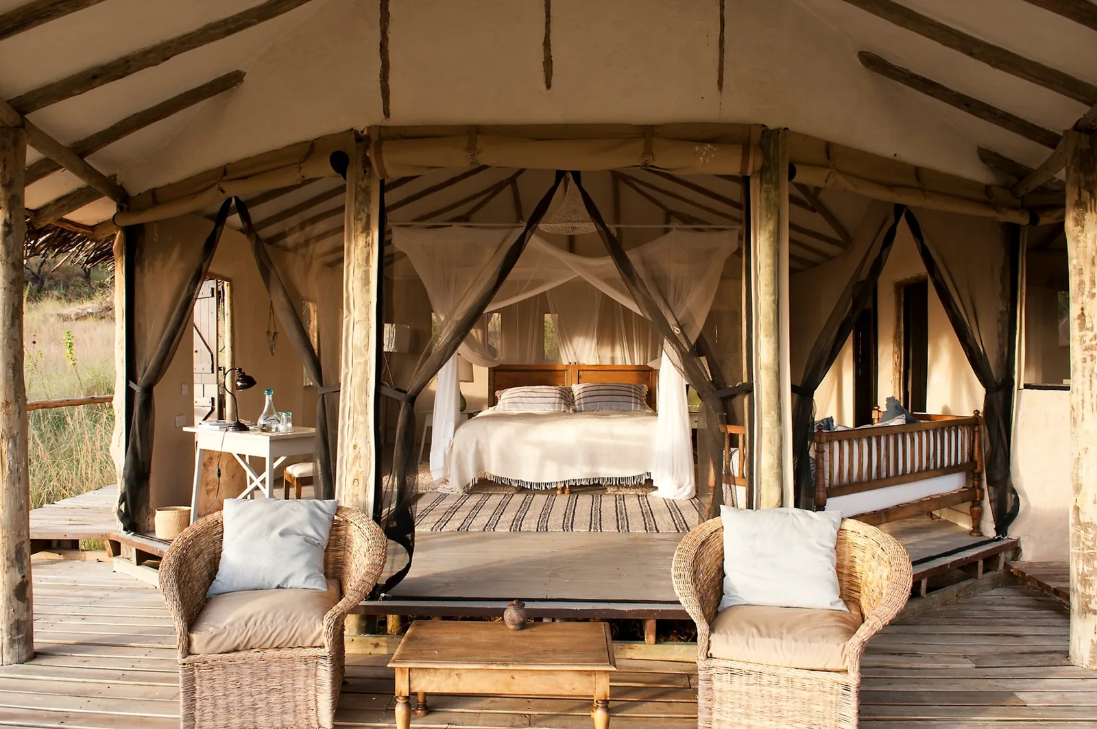 A tented room stands ready inside a river-country camp
