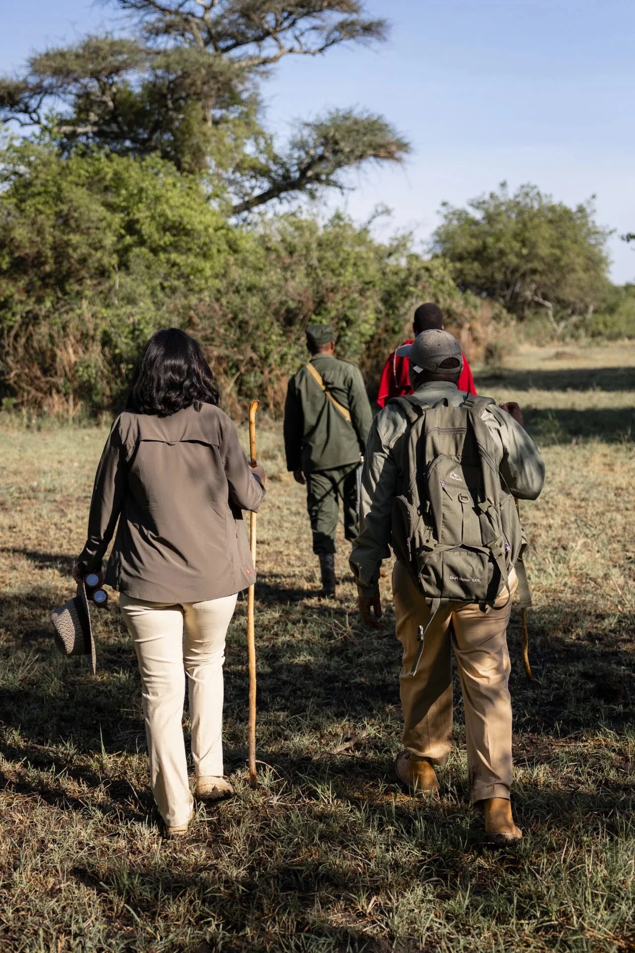 Guests walk with an armed ranger on a guided bush walk