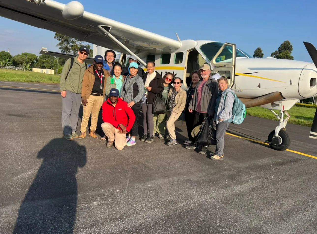Guests walk out to a light aircraft ready for take-off at a bush airstrip