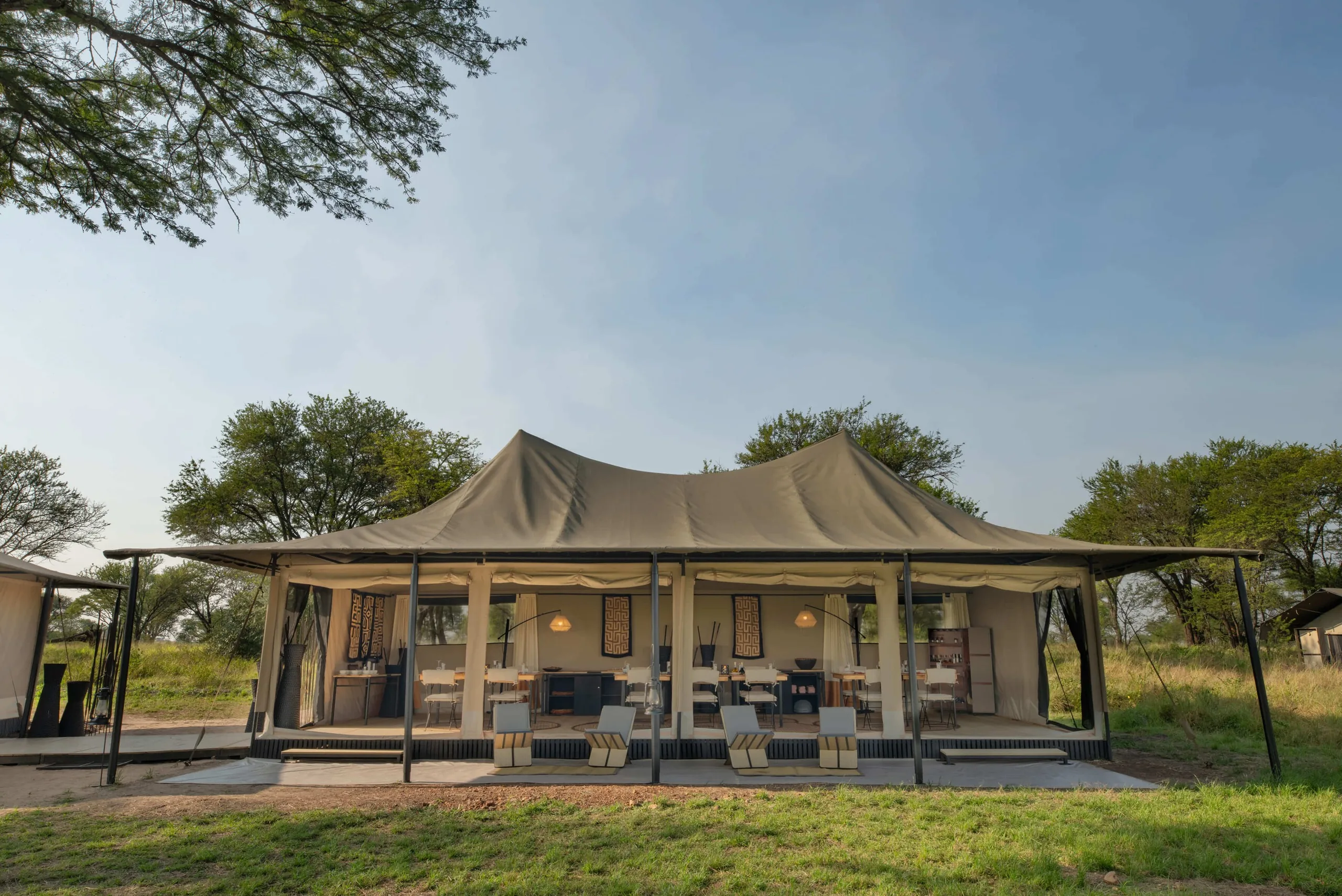 A mobile camp's main tent stands open on the northern plains