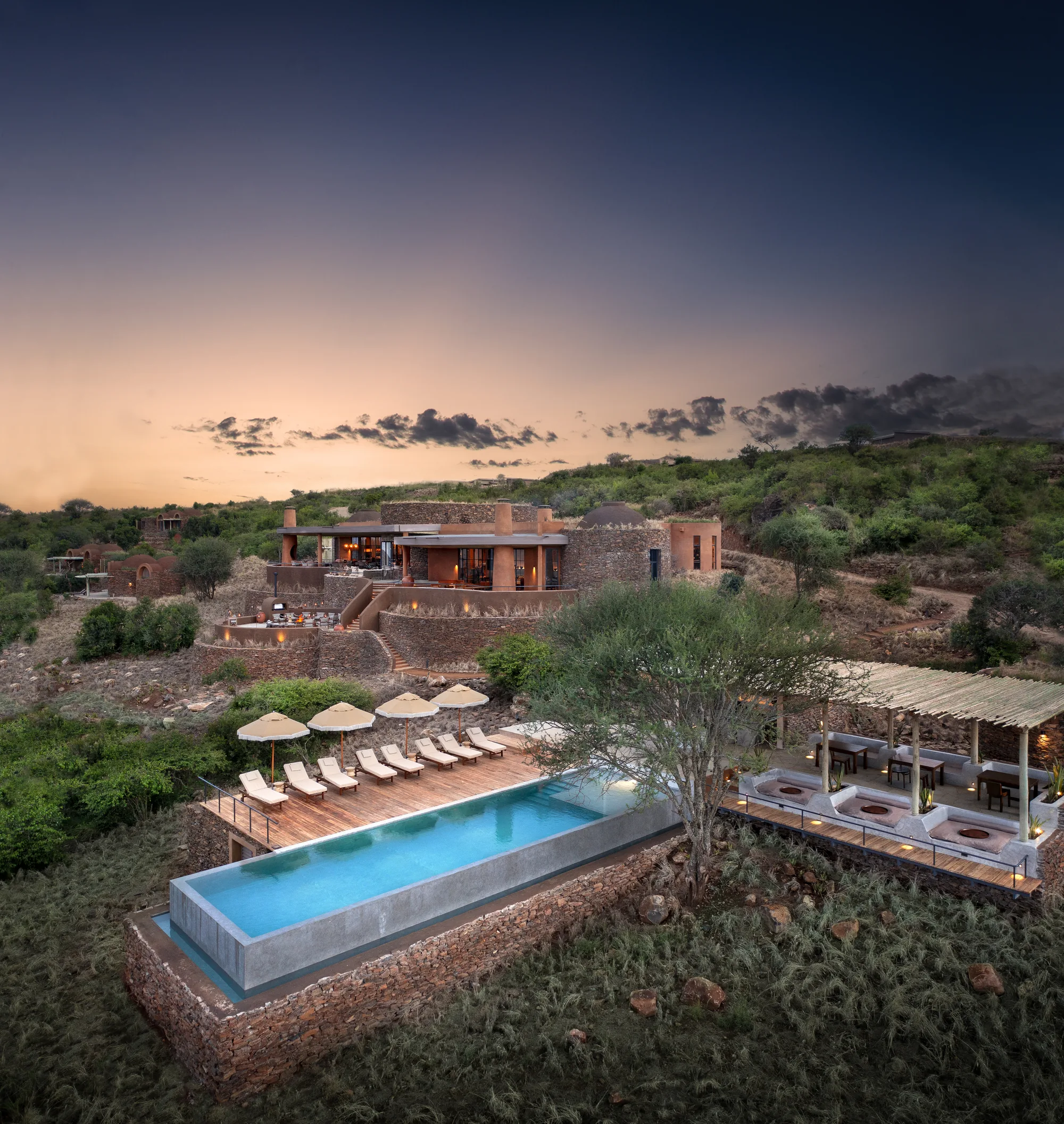 A safari lodge seen from the air in a green Laikipia landscape