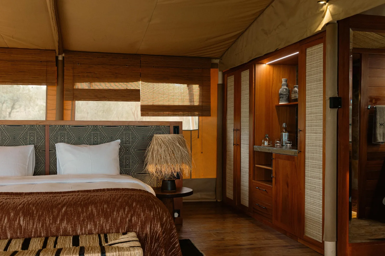 A permanent lodge suite in timber and canvas stands fully dressed