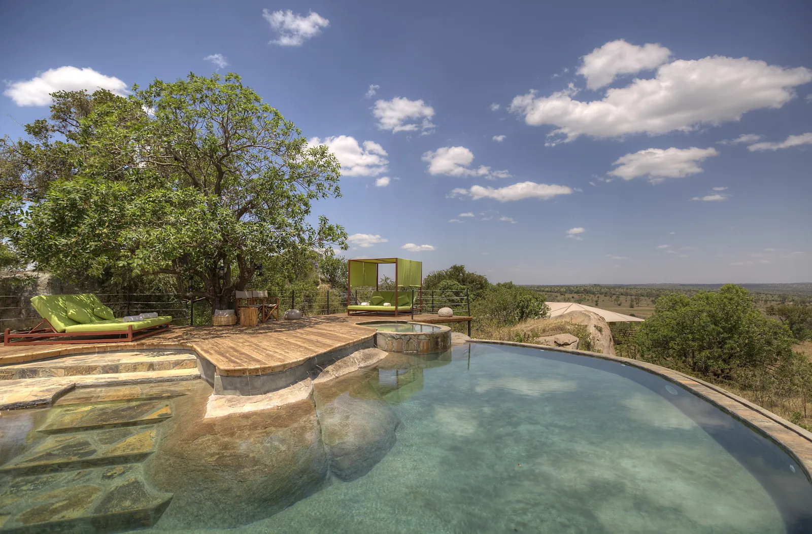 An infinity pool looks out over the Serengeti from a permanent lodge
