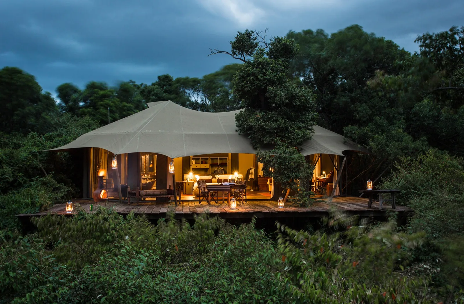 A suite glows at dusk at the end of a gentle path