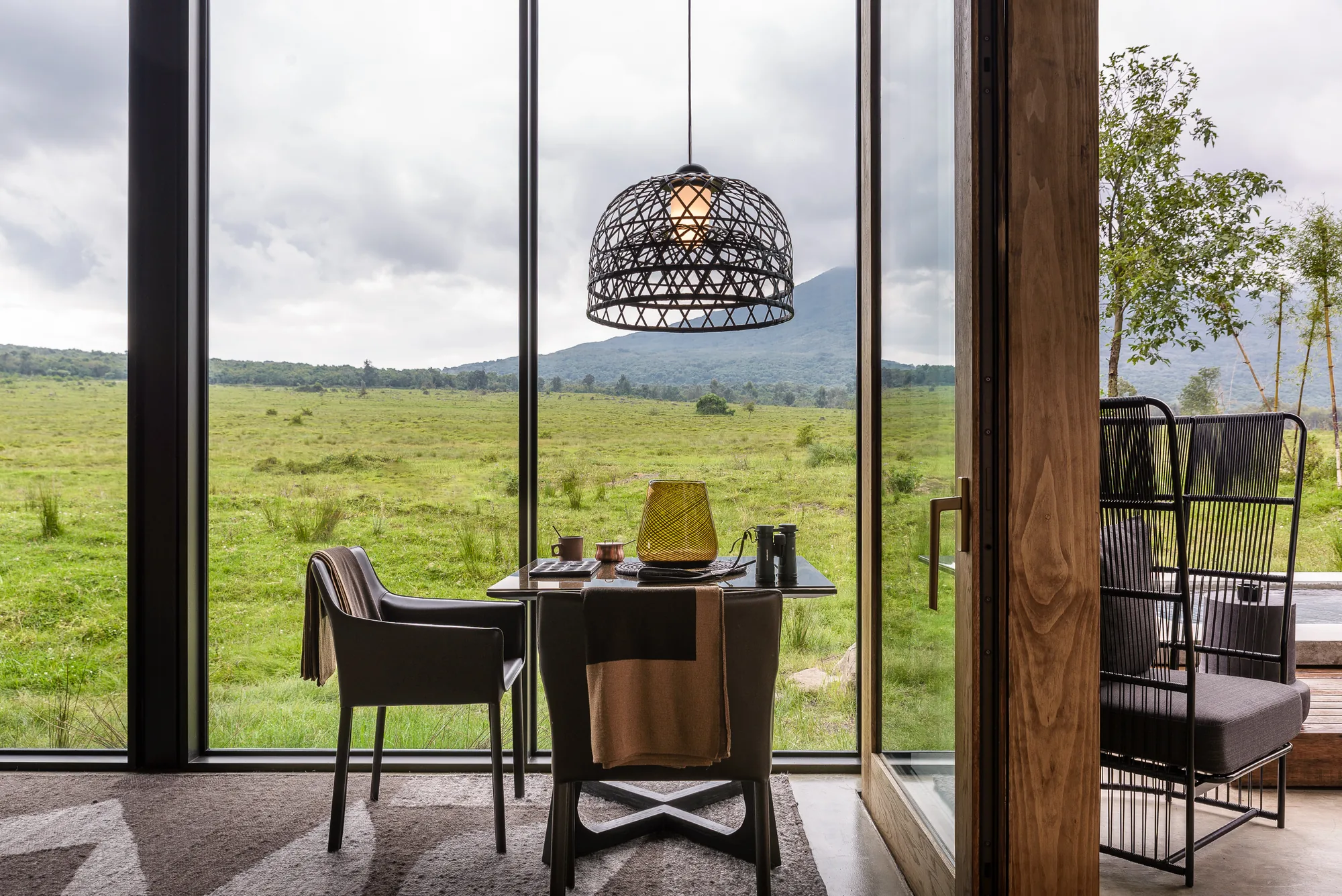 A dining table laid with a wide view over the plains