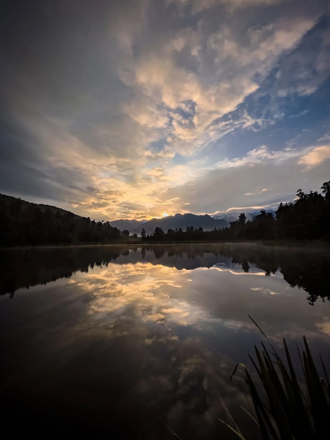 Dawn light mirrors in a still crater-highland lake