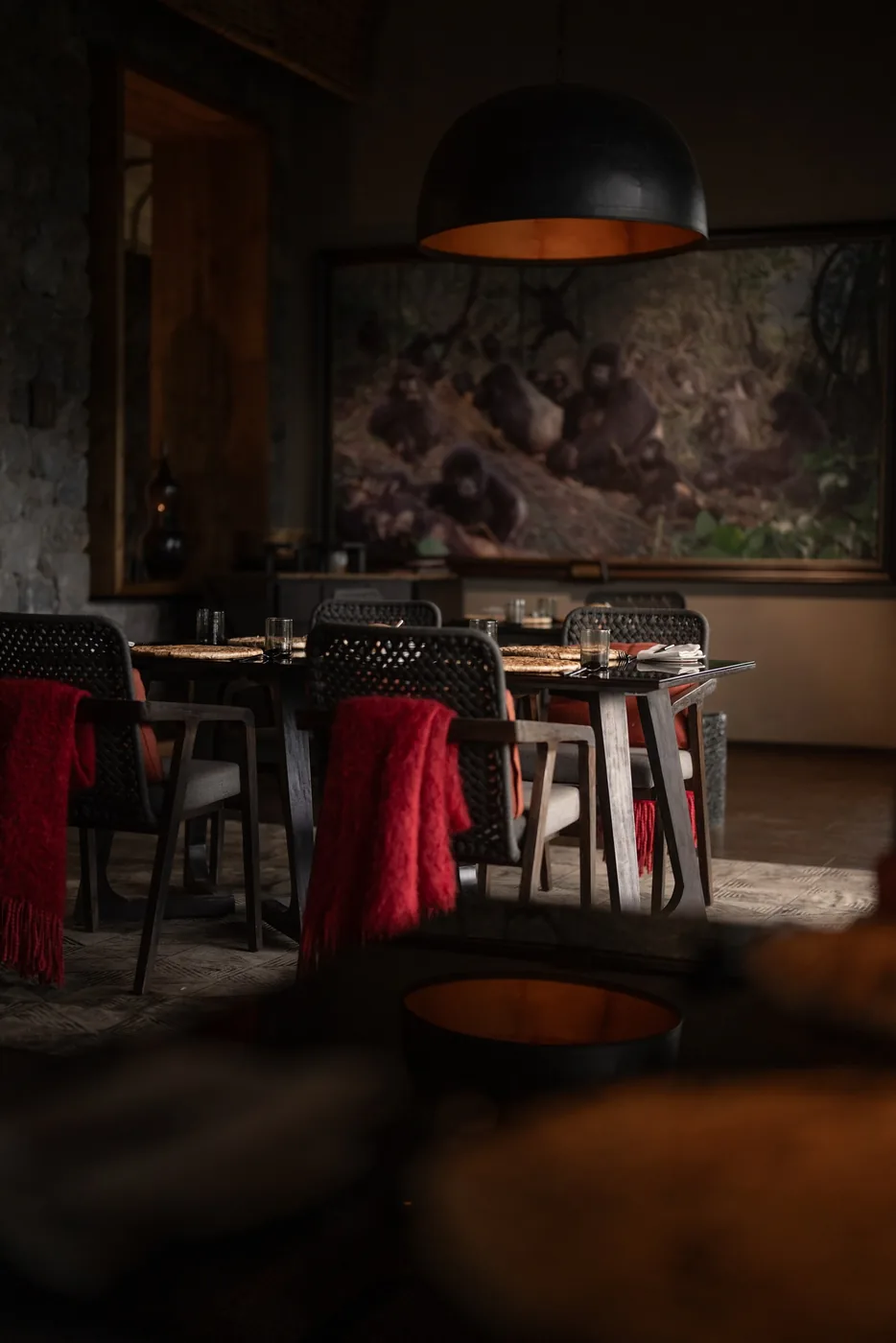 A stone dining room waits in low evening light