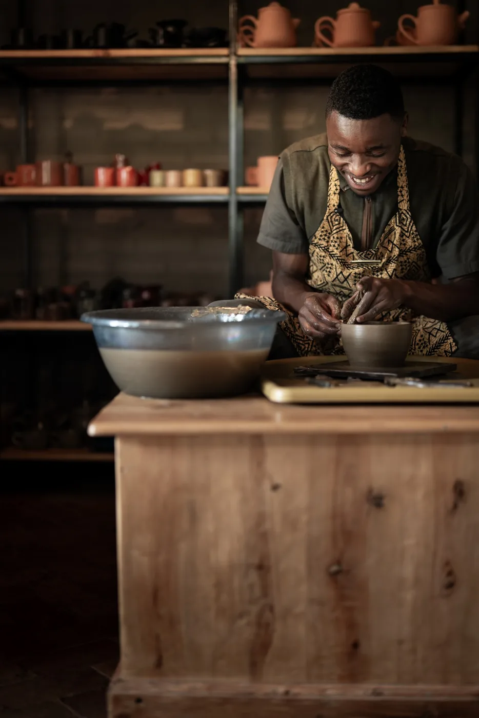 A potter shapes clay at a craft workshop