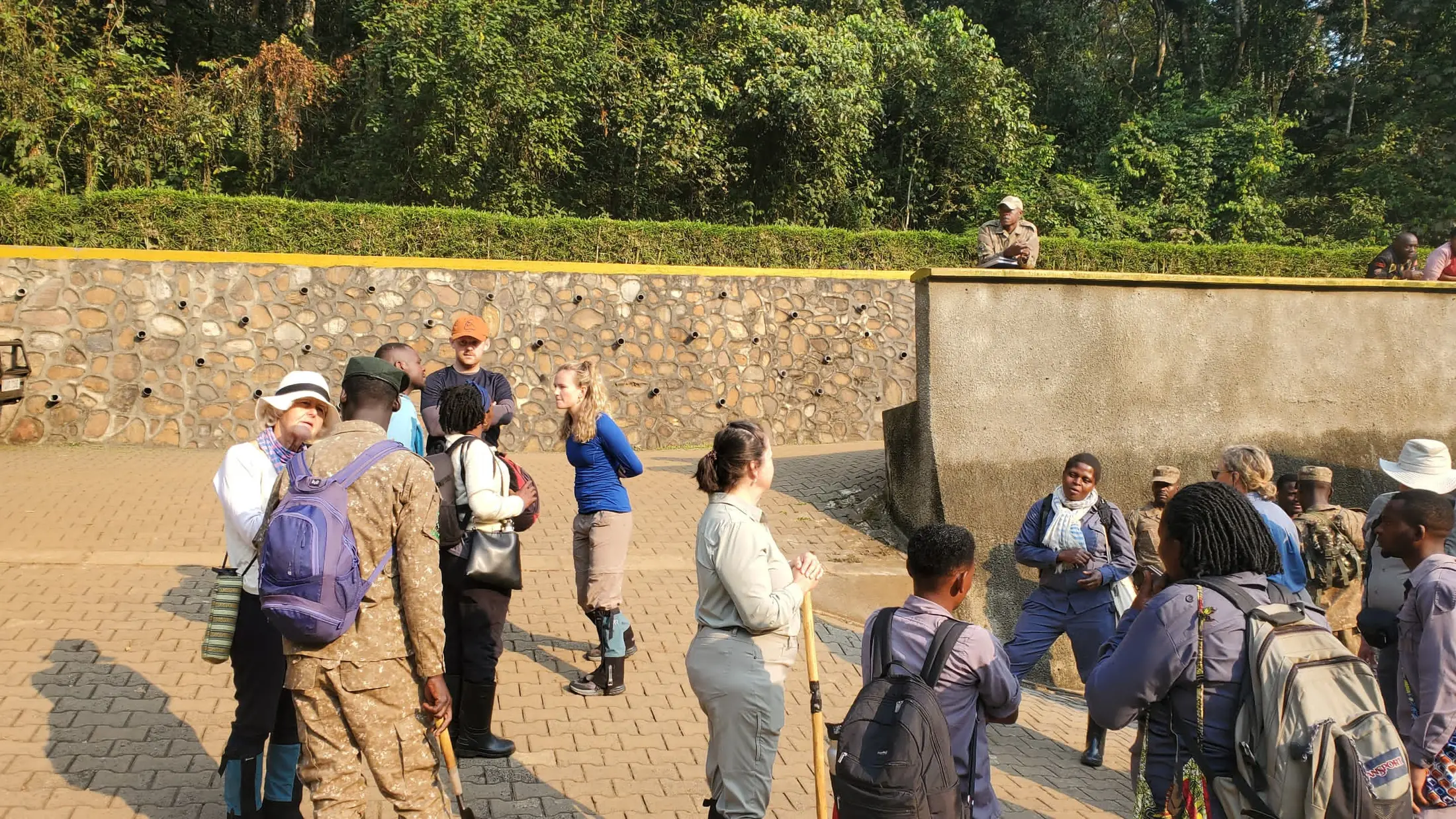 Guide briefing travellers before a gorilla trek at a Bwindi trailhead