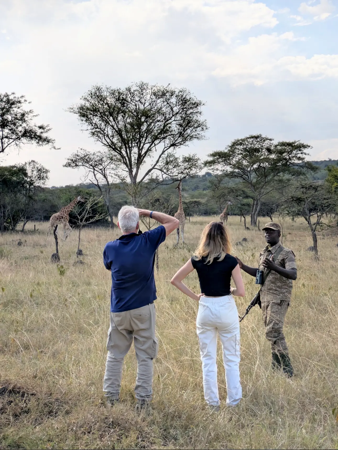 Armed wildlife ranger leading guests on a guided walking safari