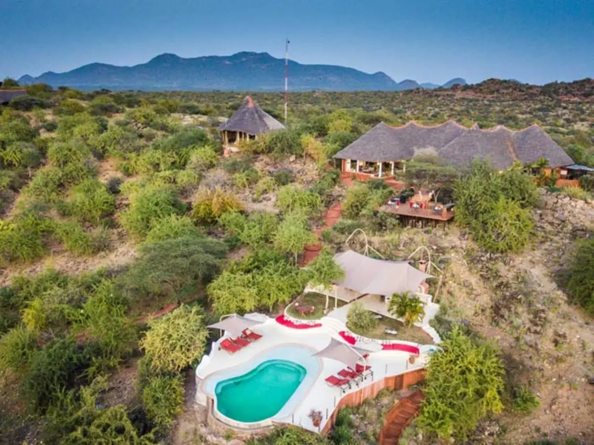 A thatched lodge and its pool sit among the dry hills of the north