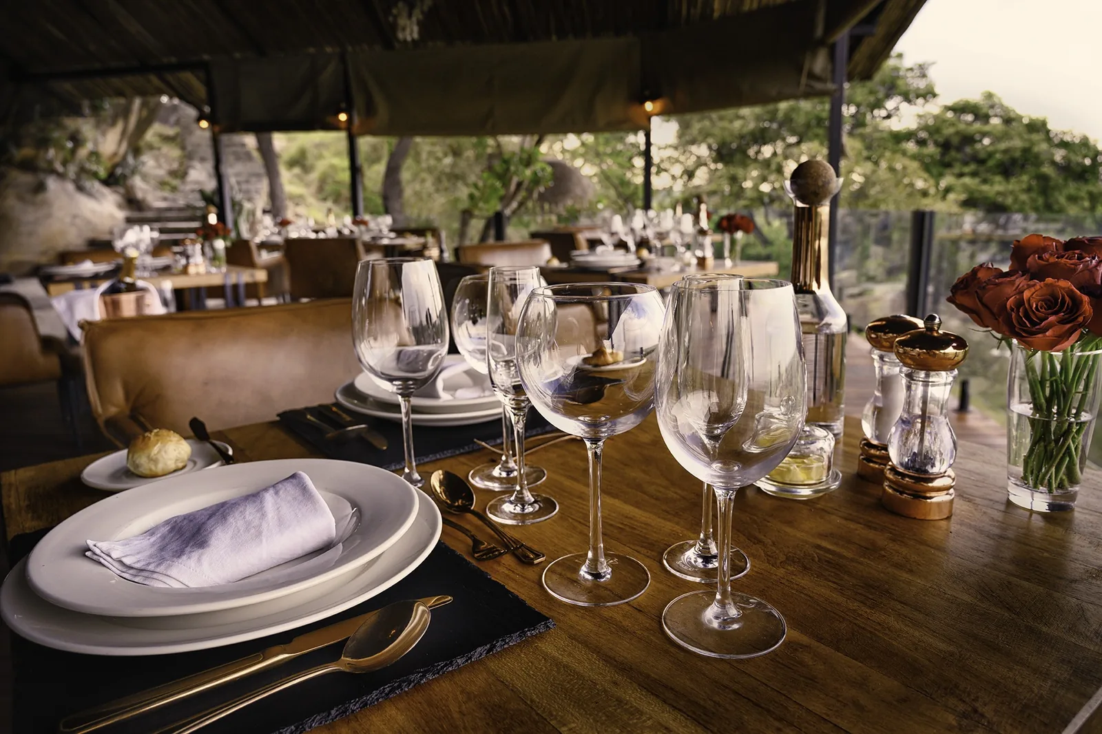 A candlelit table for two stands ready in the open