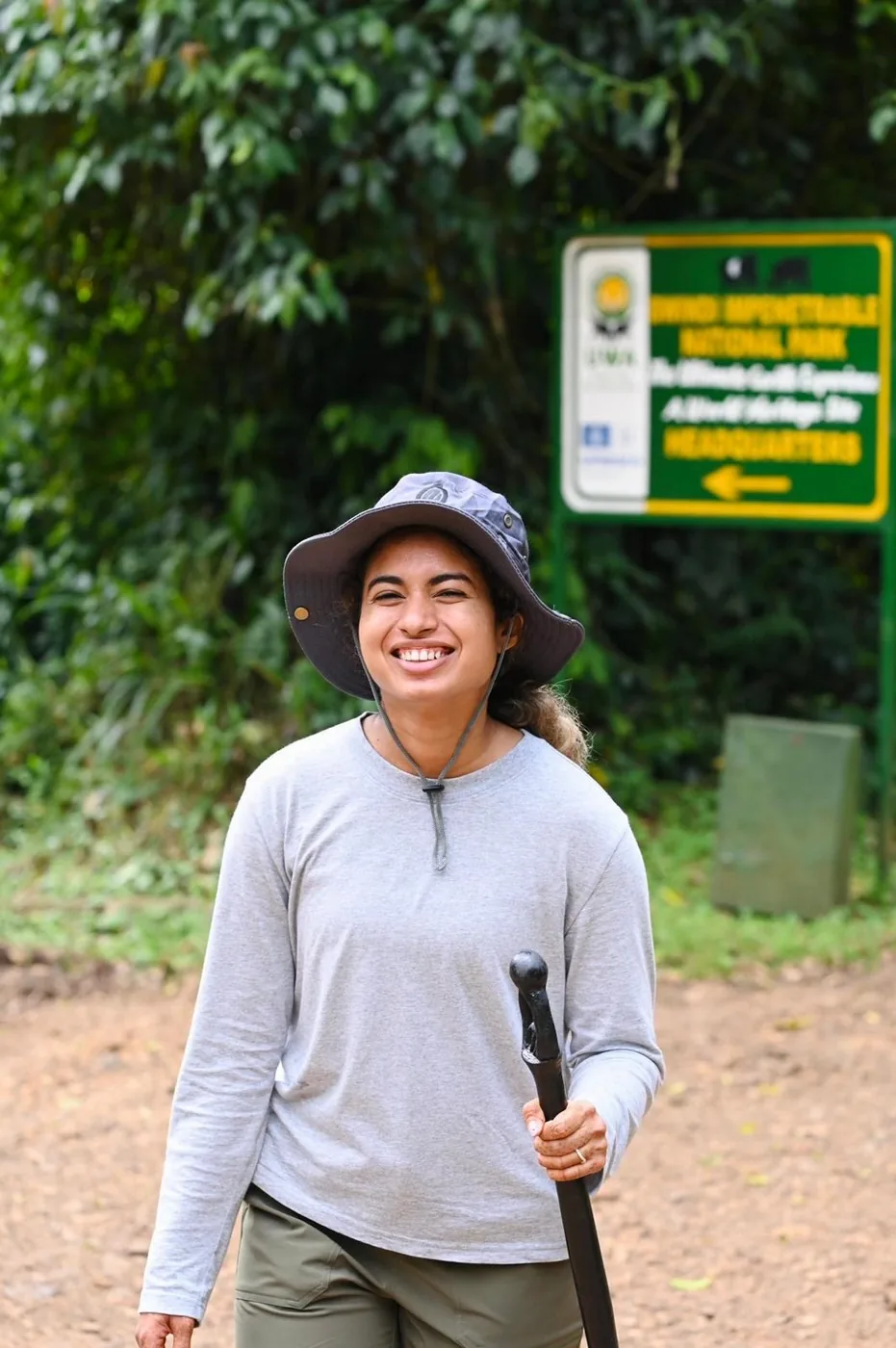 A trekker smiles at the Bwindi trailhead after the morning's walk
