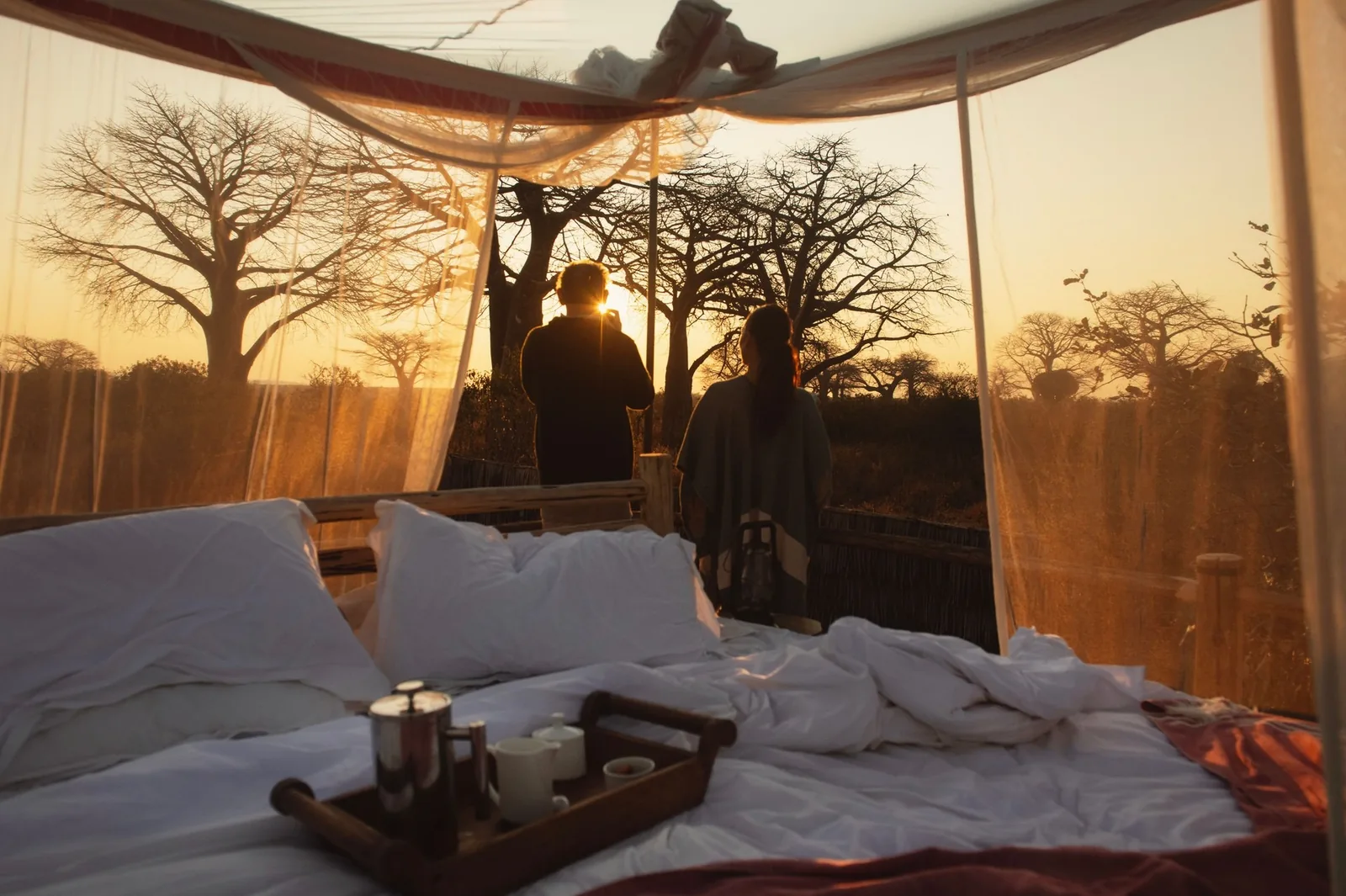 A star bed stands open to the baobab evening in Ruaha