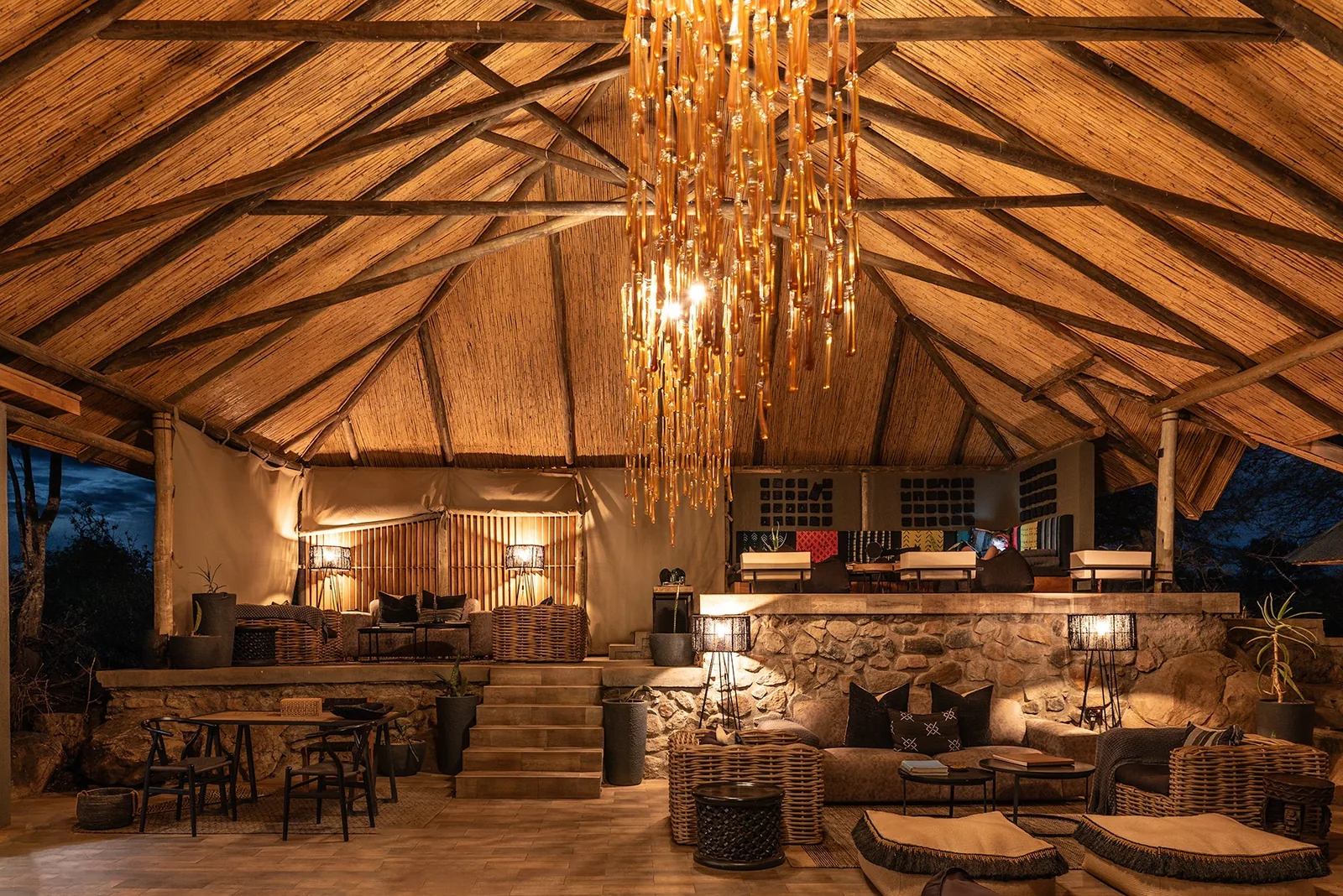 A tented camp lounge glows in the evening
