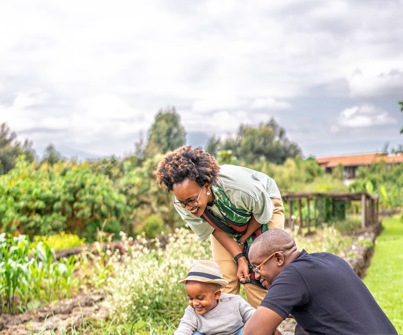 A family walks among planting beds in the Akarabo garden at Singita Volcanoes, Rwanda