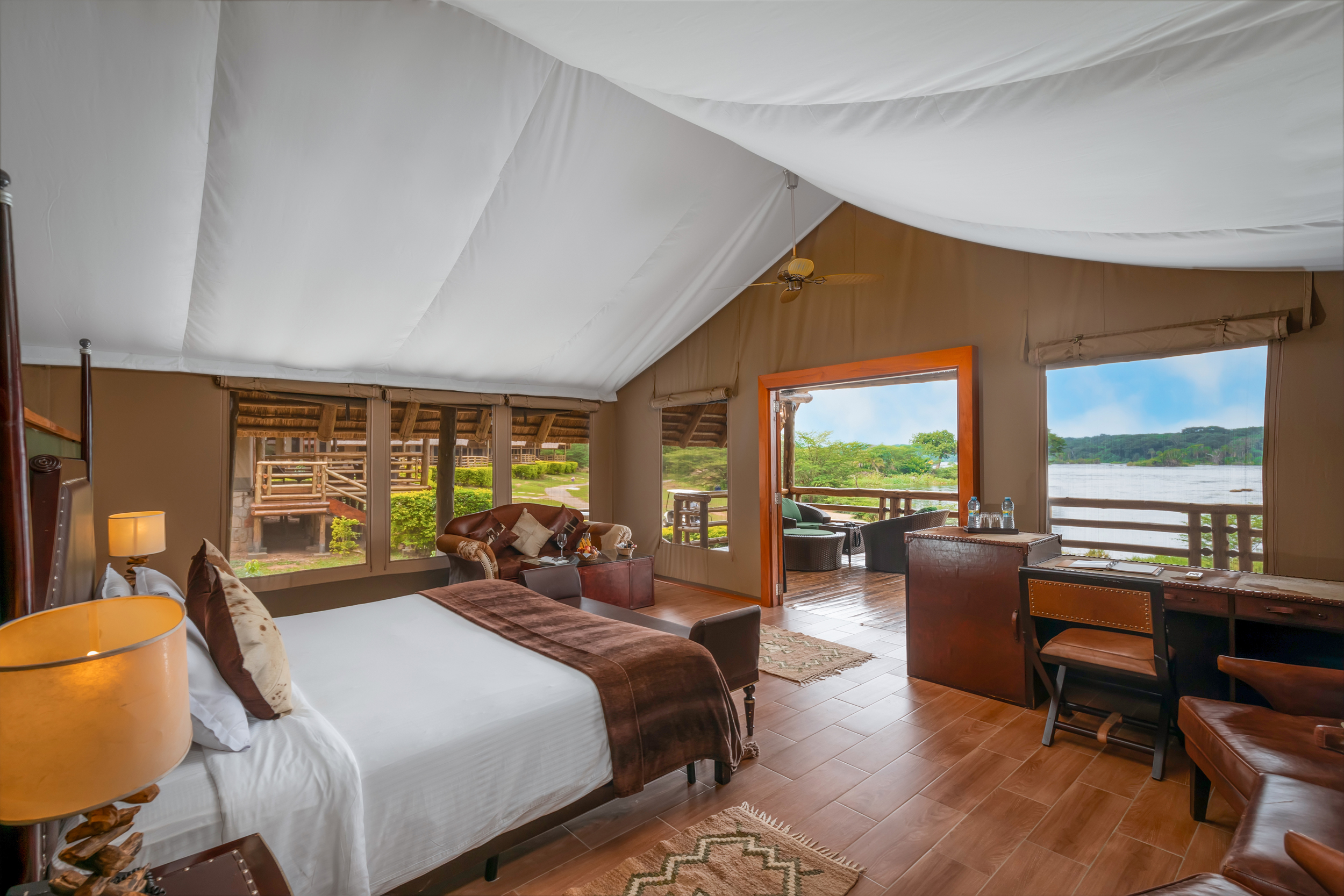 A tent room at Chobe Safari Lodge, the bed facing windows that look out over the Nile