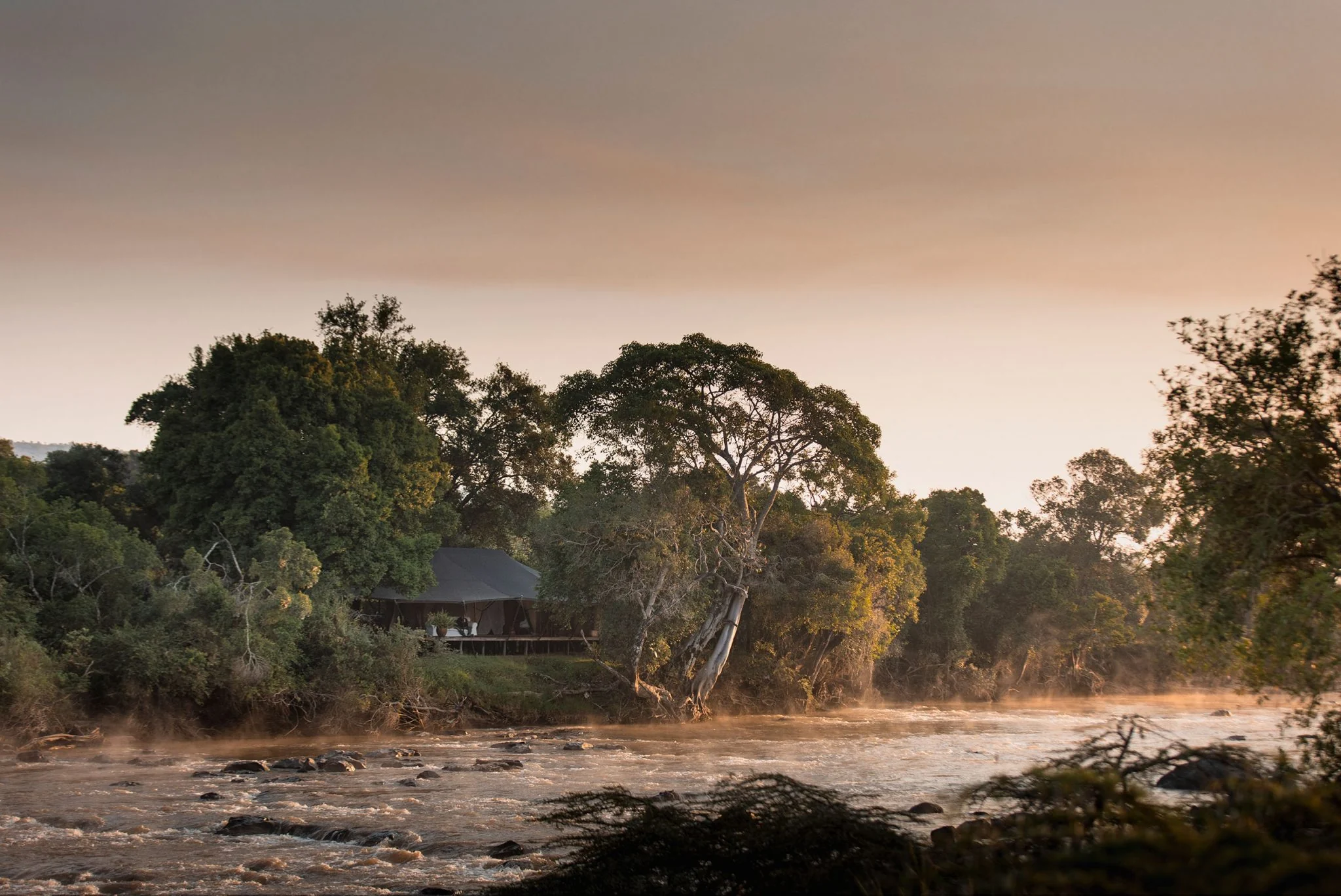 Tents beside the river at dawn