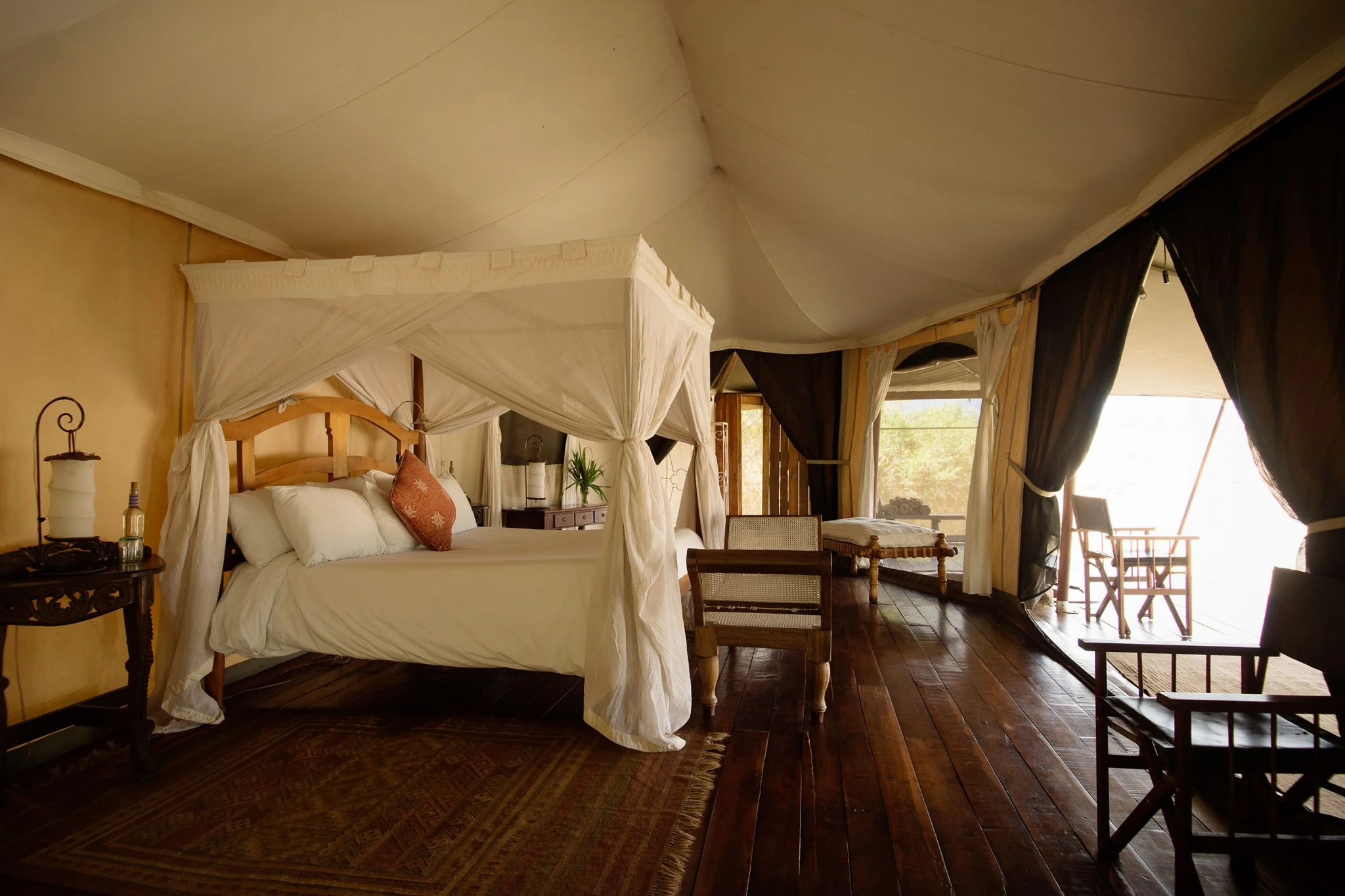 A tent bedroom with a four-poster bed