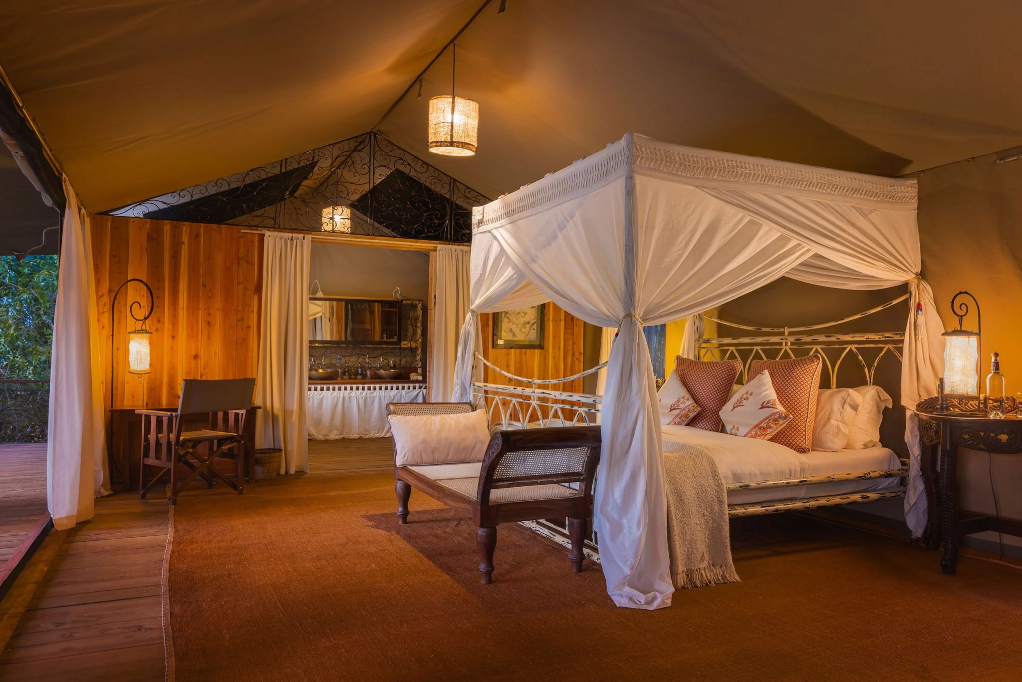 A tent bedroom with a four-poster bed