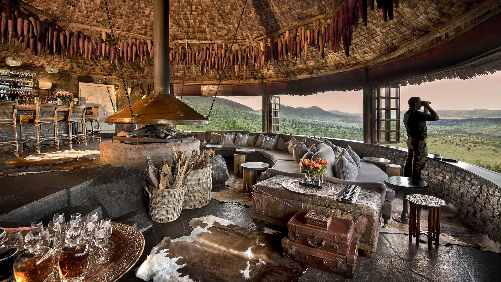 The bar and lounge under a thatched roof, open to the view