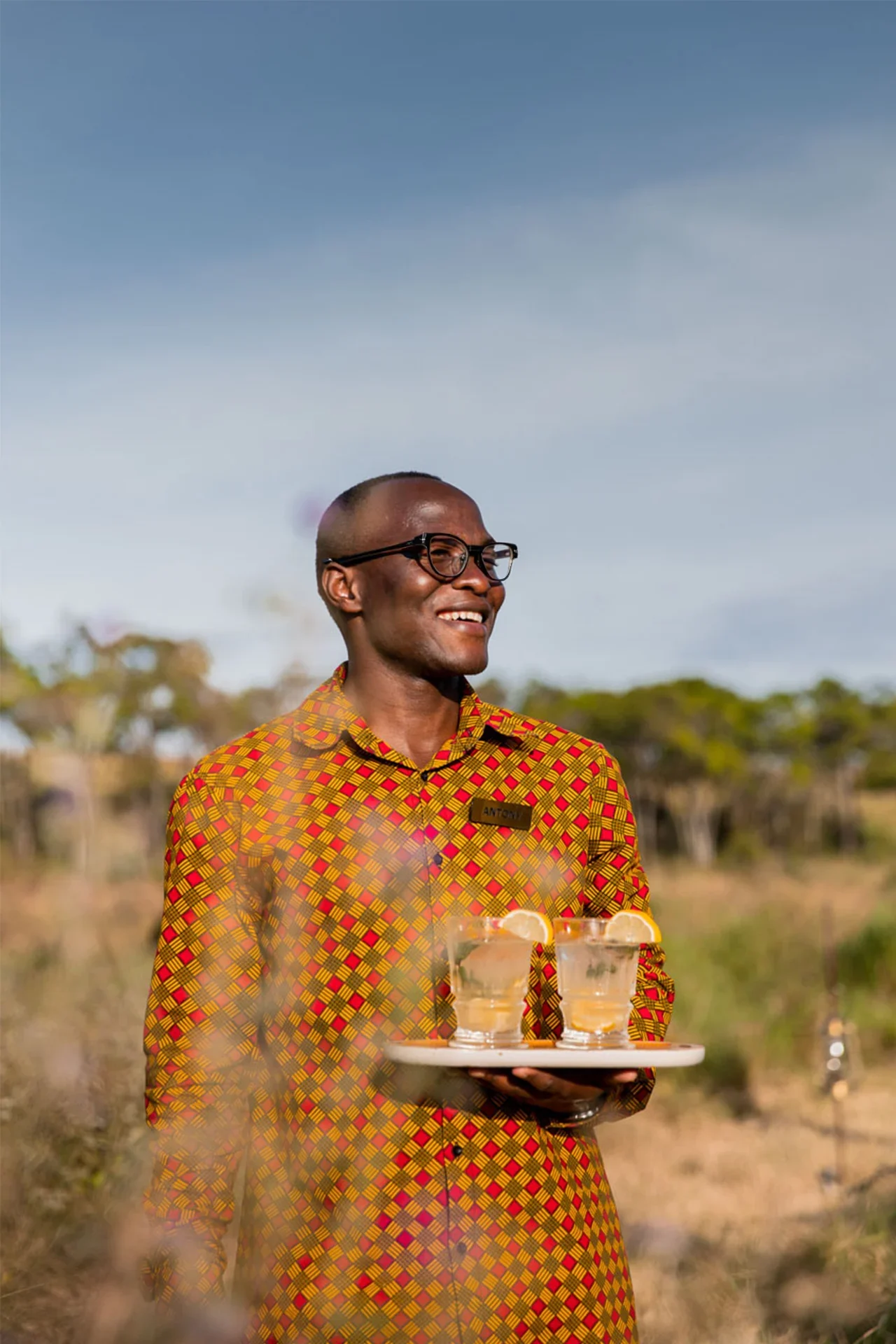 A member of staff carrying a tray of drinks
