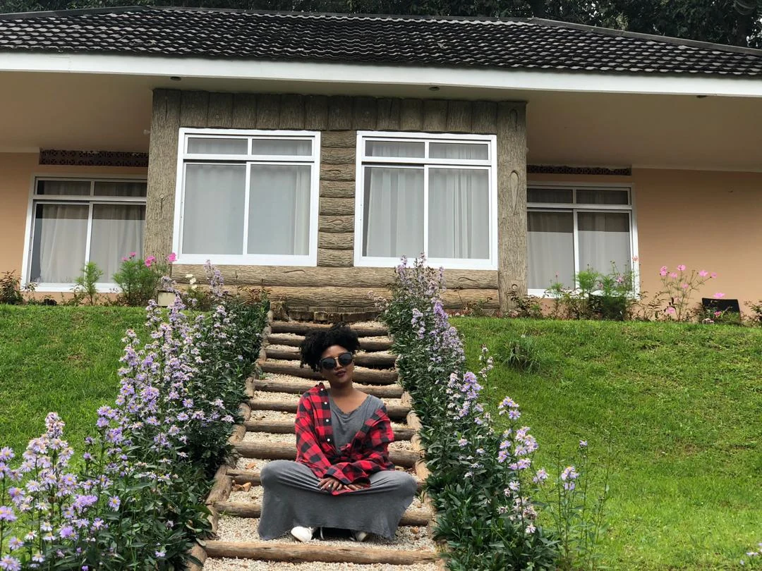 A guest sitting on the steps of a cottage