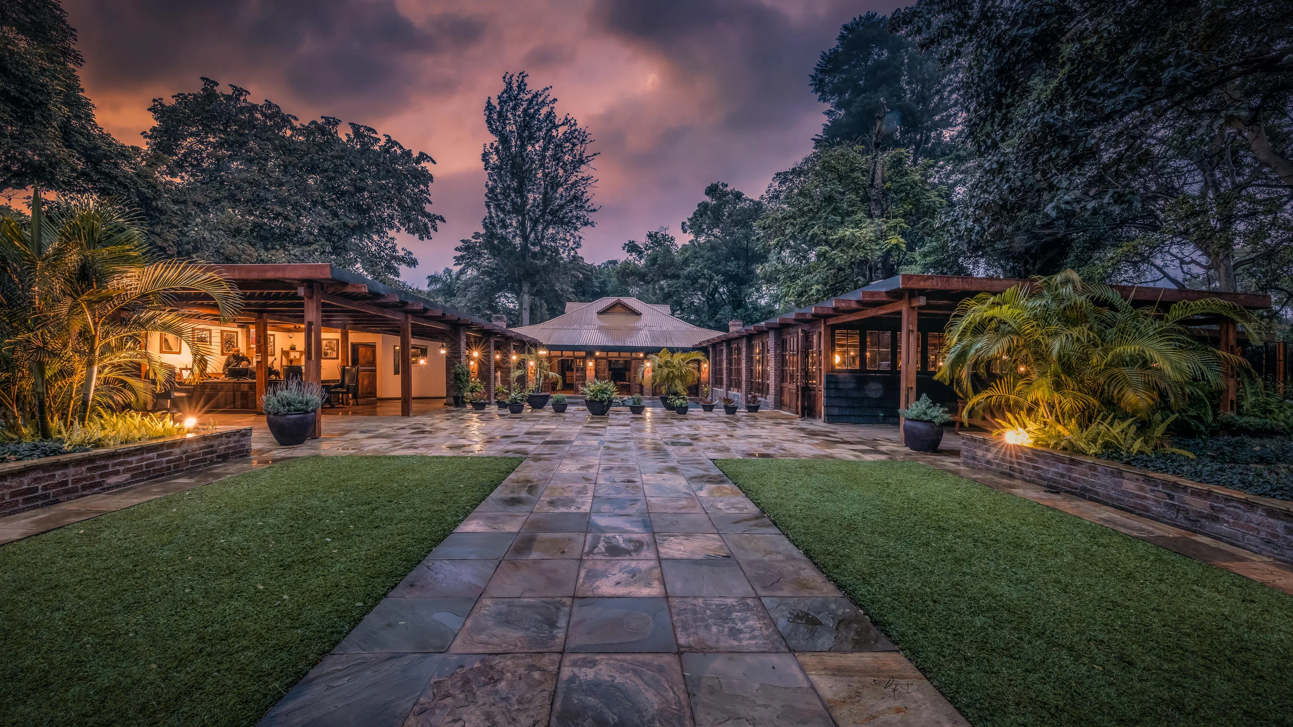 The main building at dusk, seen along the lawn