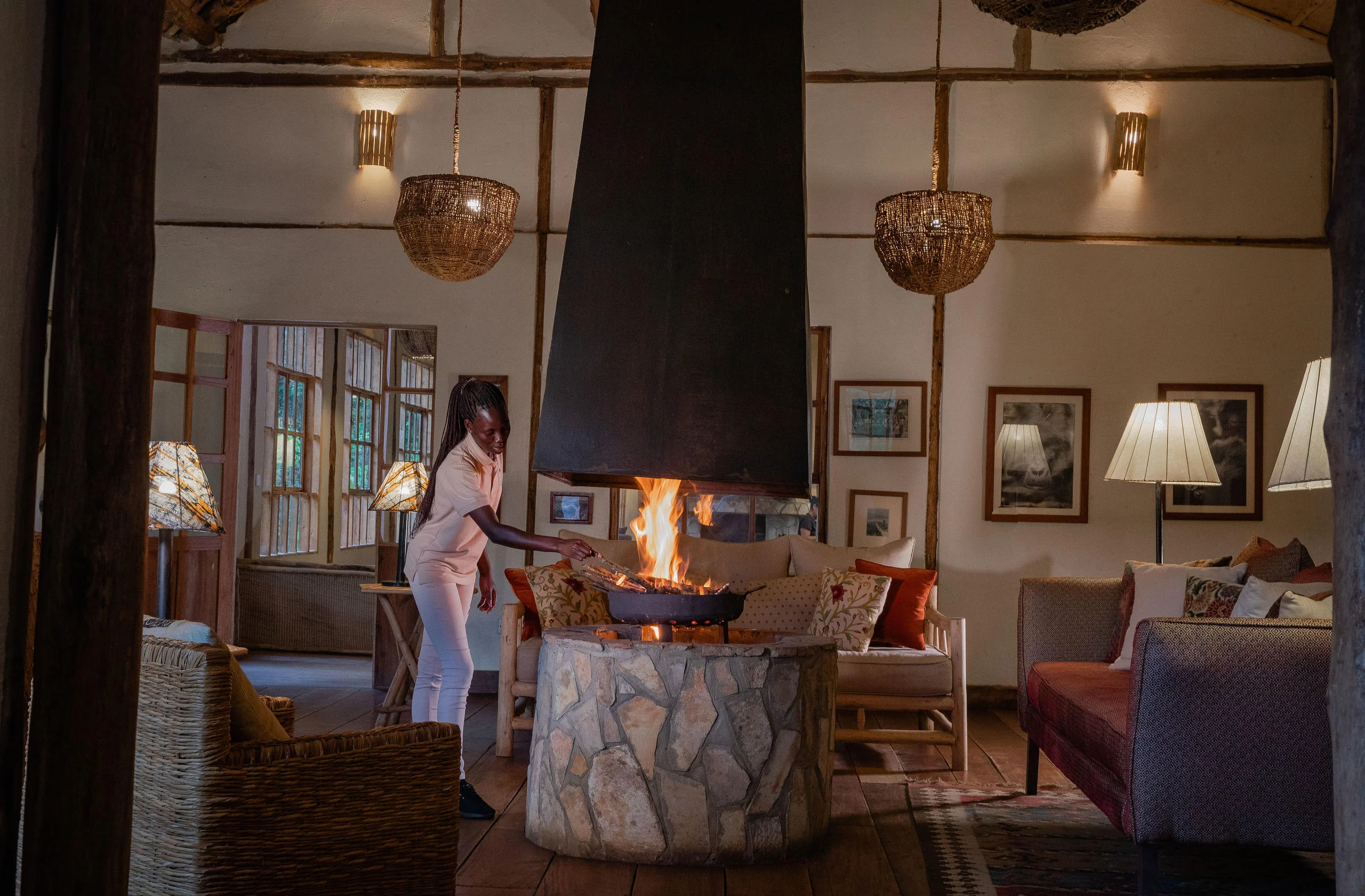 A member of staff tending the fire in the lounge