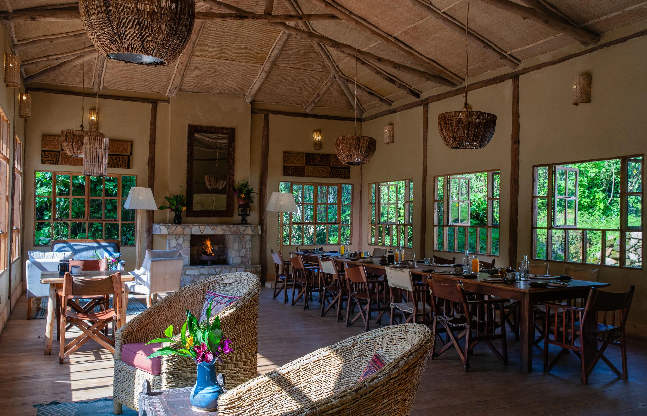 The dining room with tables laid, looking into the forest