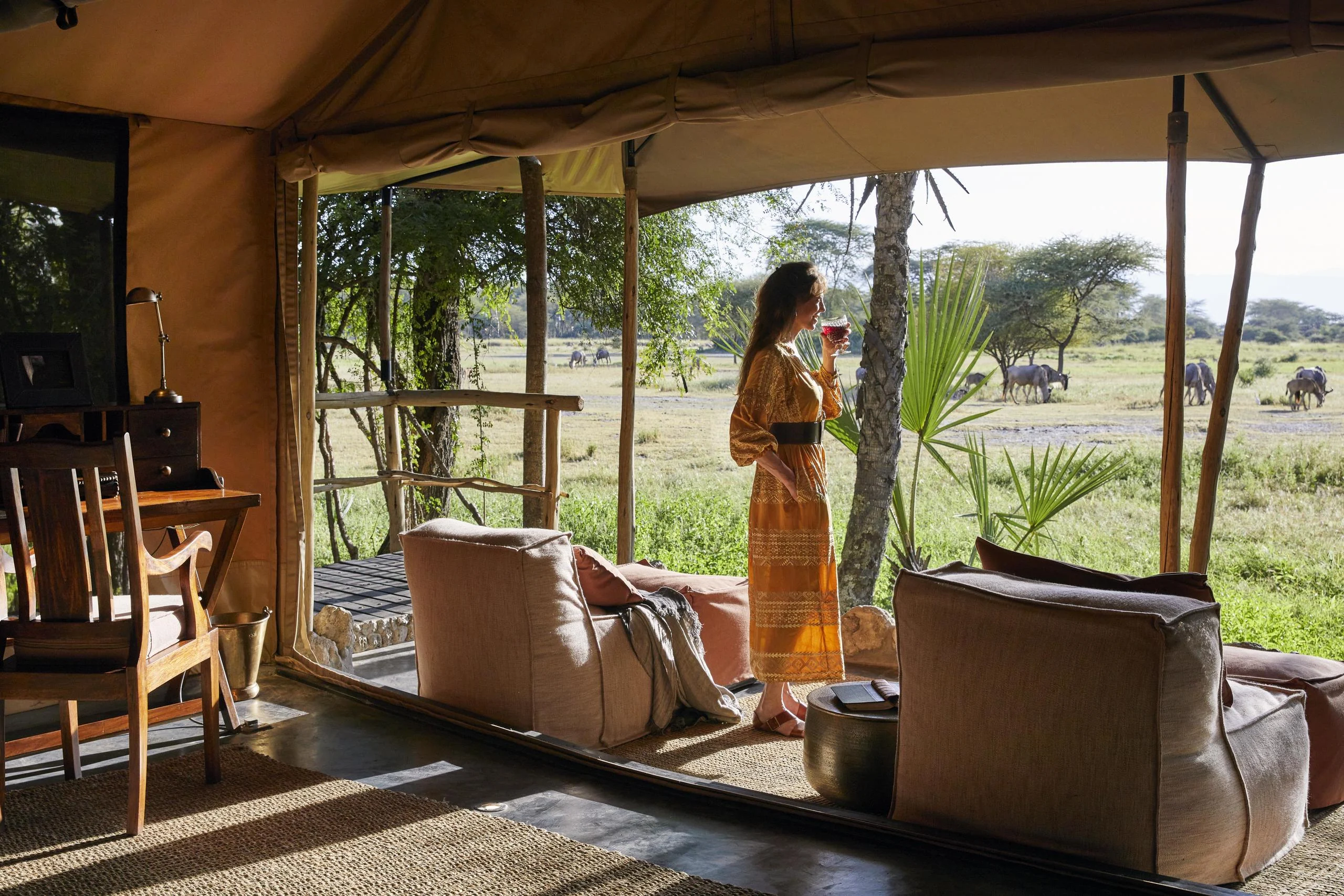 A guest in the lounge tent looking out to the plains