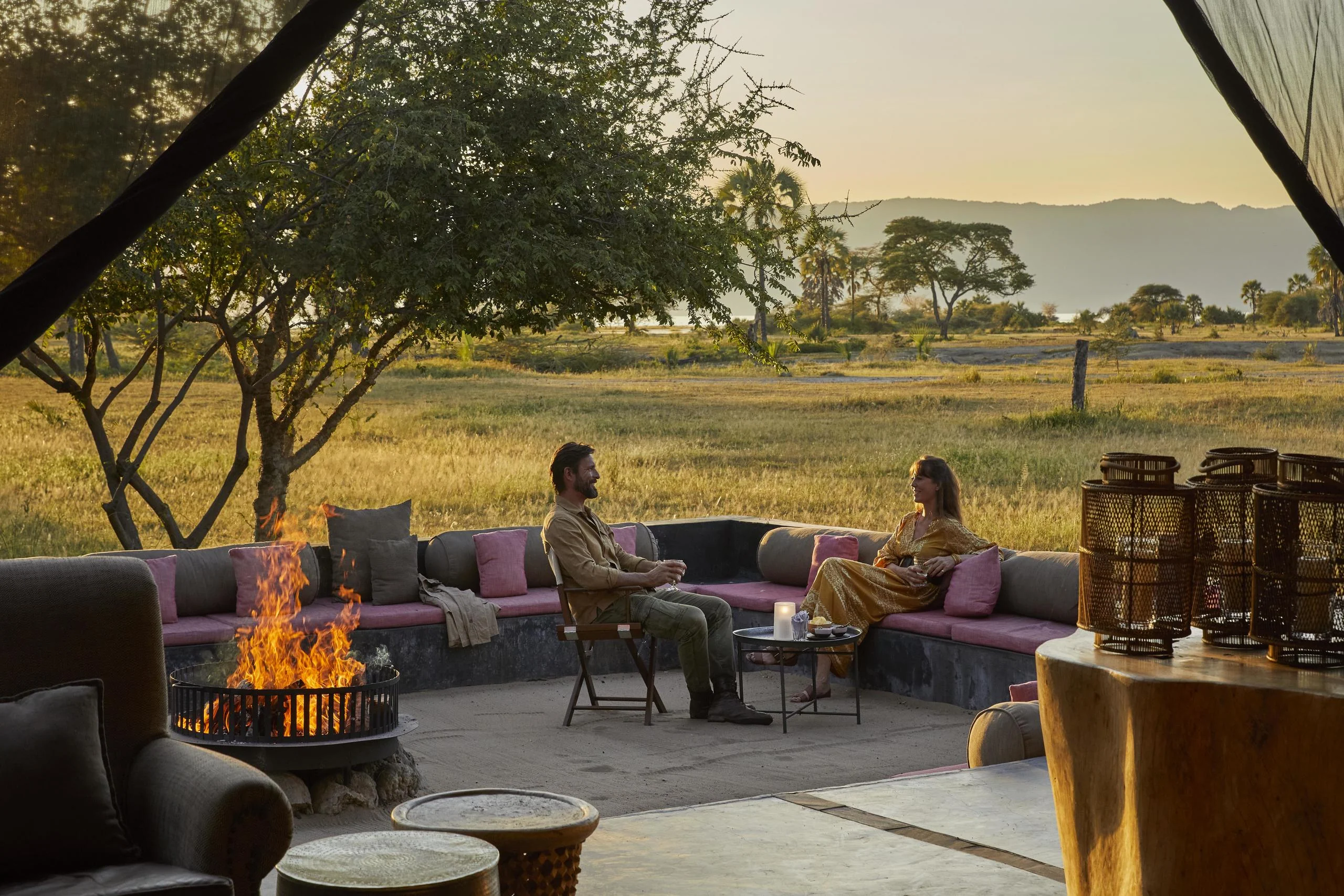 Guests on the terrace beside the fire at dusk