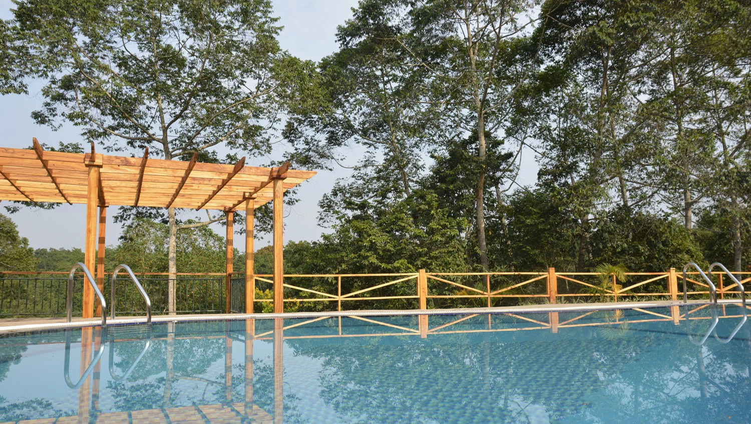 The pool with a timber pergola beside it